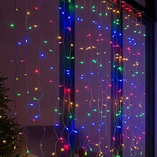 300 LED Curtain String Lights — 9.8 × 9.8 ft, multicolor, hanging in a window